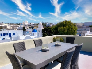 top floor courtyard with outdoor dining and panoramic views at Mansion Kyani