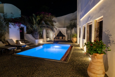 Night photo of courtyard and pool of Mansion sophia heritage villa in Megalochori Santorini