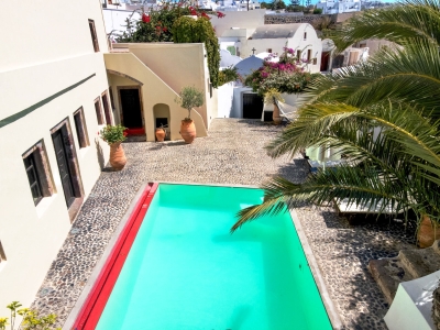 Day photo from above of the pool of Mansion sophia heritage villa in Megalochori Santorini