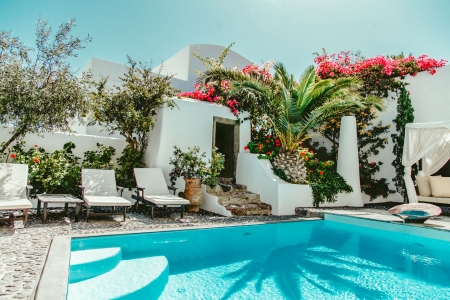 Mansion sophia heritage villa private pool palm tree and flowers day shot in Megalochori Santorini