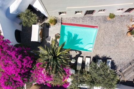 Birds eye view of courtyard and pool of Mansion sophia heritage villa in Megalochori Santorini