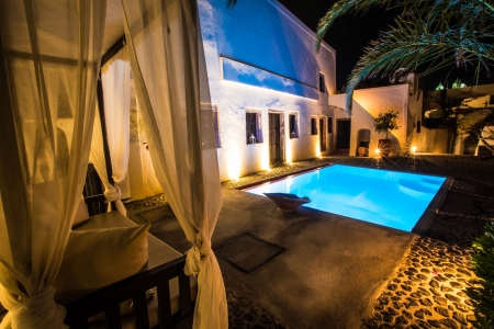 Mansion sophia heritage villa exterior pool view by night in Megalochori Santorini