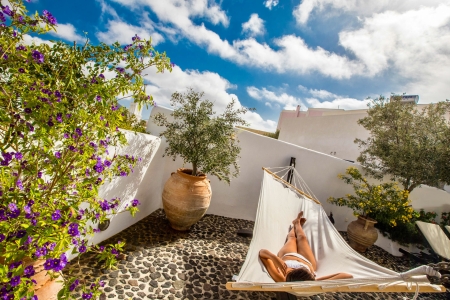 A lady relaxes at the hammock of mansion sophia in Megalochori Santorini
