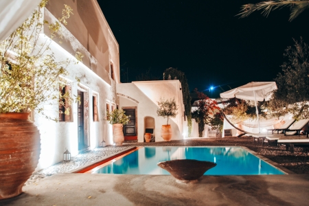 Night photo of courtyard and pool of Mansion sophia heritage villa in Megalochori Santorini
