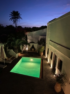 Night photo from above of courtyard and pool of Mansion sophia heritage villa in Megalochori Santorini