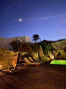 Night moon photo of courtyard and pool of Mansion sophia heritage villa in Megalochori Santorini