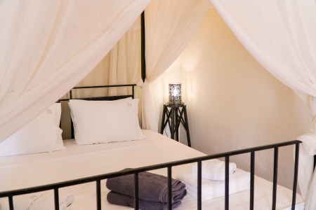 Master bedroom bed of Mansion sophia heritage villa in Megalochori Santorini