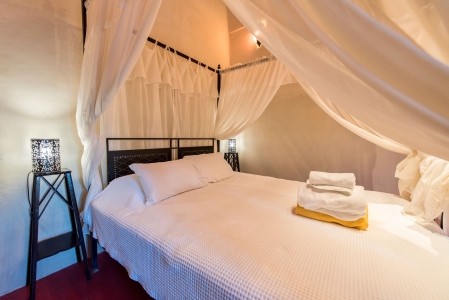 Master bedroom bed of Mansion sophia heritage villa in Megalochori Santorini